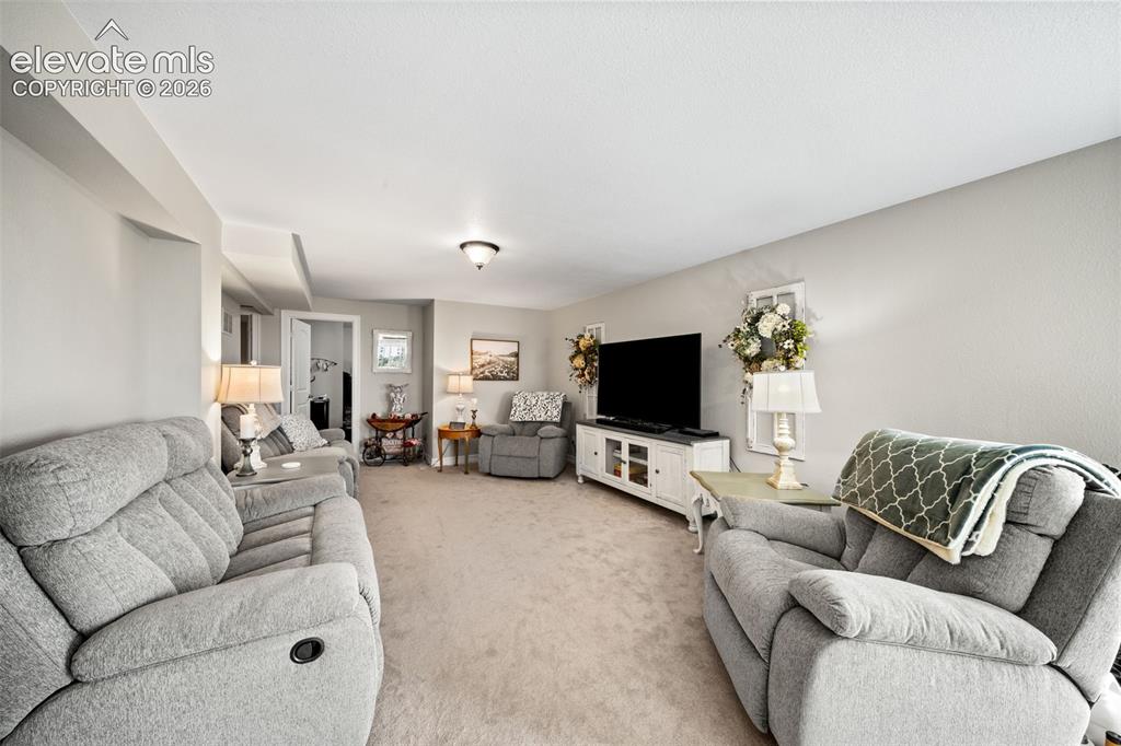 Image 27 of 50: Spacious room featuring neutral carpeting, light gray walls, and recessed l