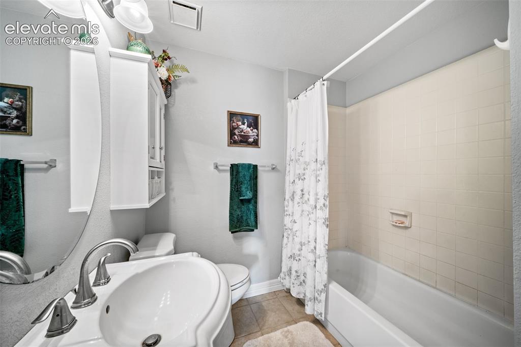 Image 31 of 50: Full bathroom featuring a pedestal sink with brushed nickel faucet, a wall-