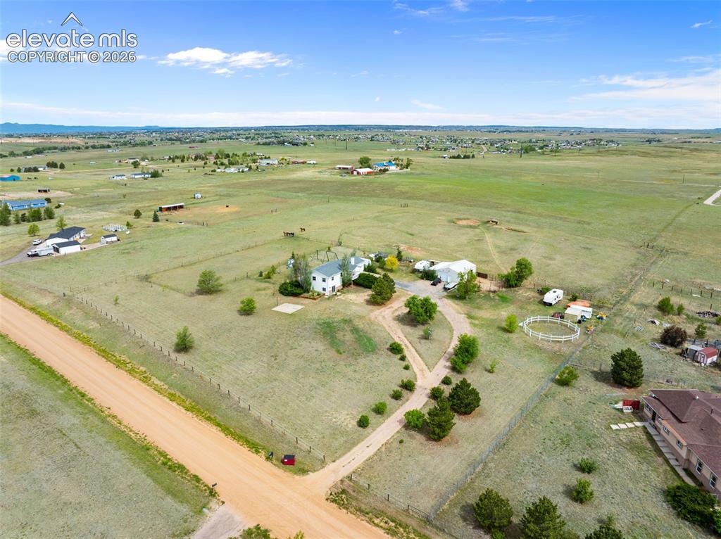 Image 49 of 50: Expansive rural property featuring a main residence, multiple outbuildings,