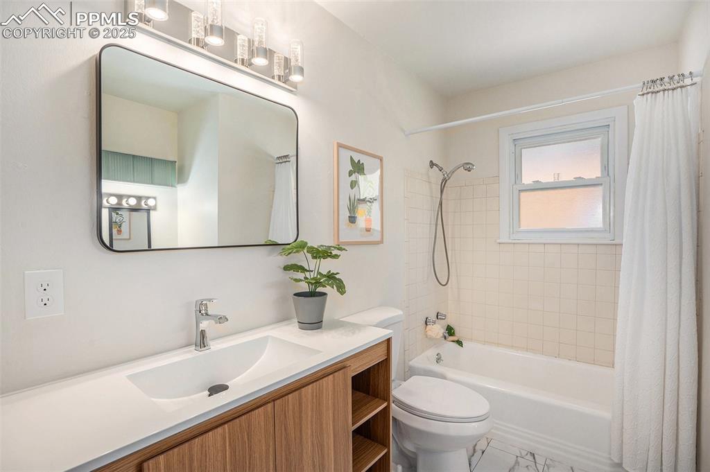 Image 12 of 24: Full bath with shower / bathtub combination with curtain and vanity