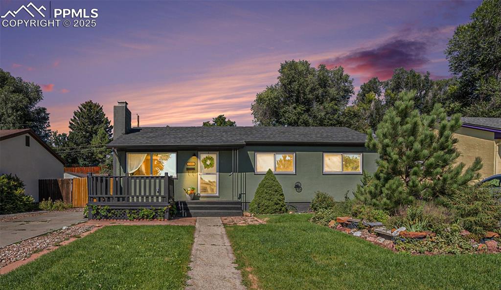 Image 18 of 24: Bungalow featuring a chimney, a front lawn, stucco siding, and a shingled r