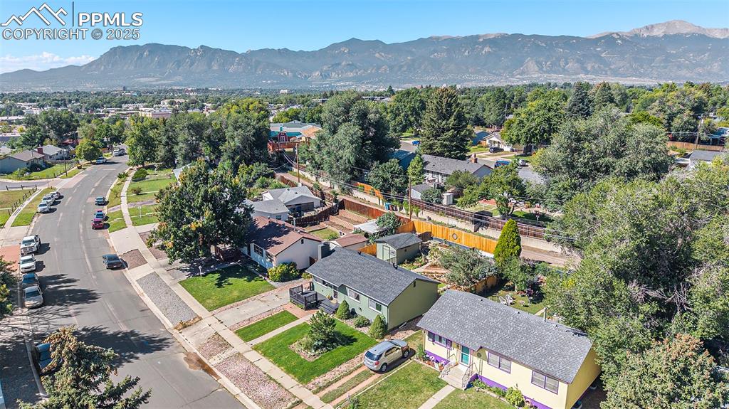 Image 2 of 24: Aerial view of residential area with a mountain backdrop