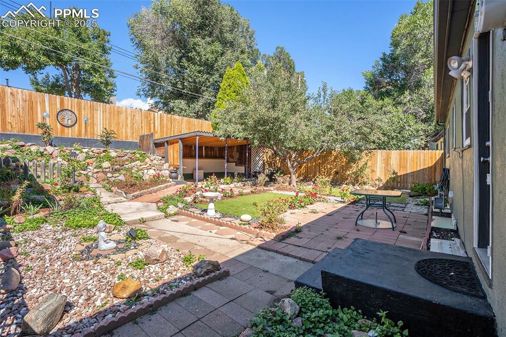 Image 20 of 24: Fenced backyard featuring a patio