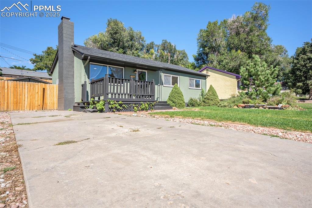 Image 24 of 24: View of front of house featuring a chimney and stucco siding