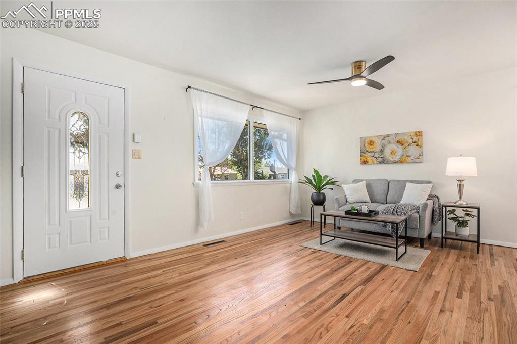 Image 3 of 24: Entrance foyer with light wood-style floors and ceiling fan