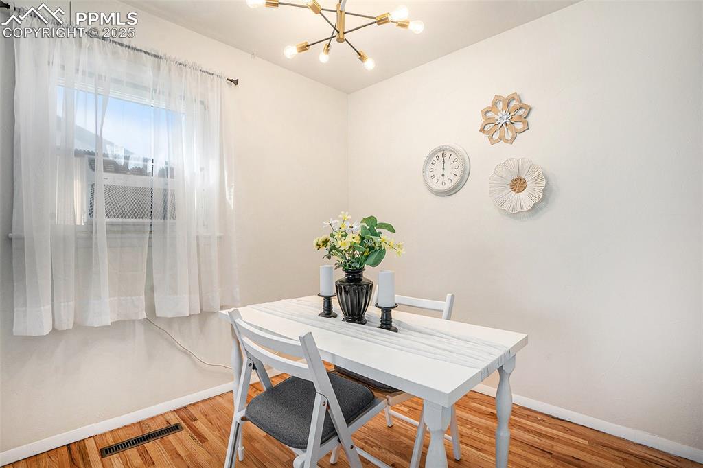 Image 6 of 24: Dining space featuring a chandelier and light wood-style flooring