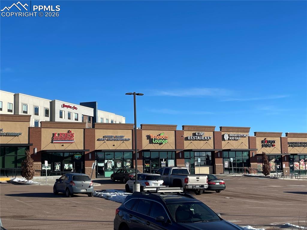 Image 4 of 12: View of commercial property with uncovered parking