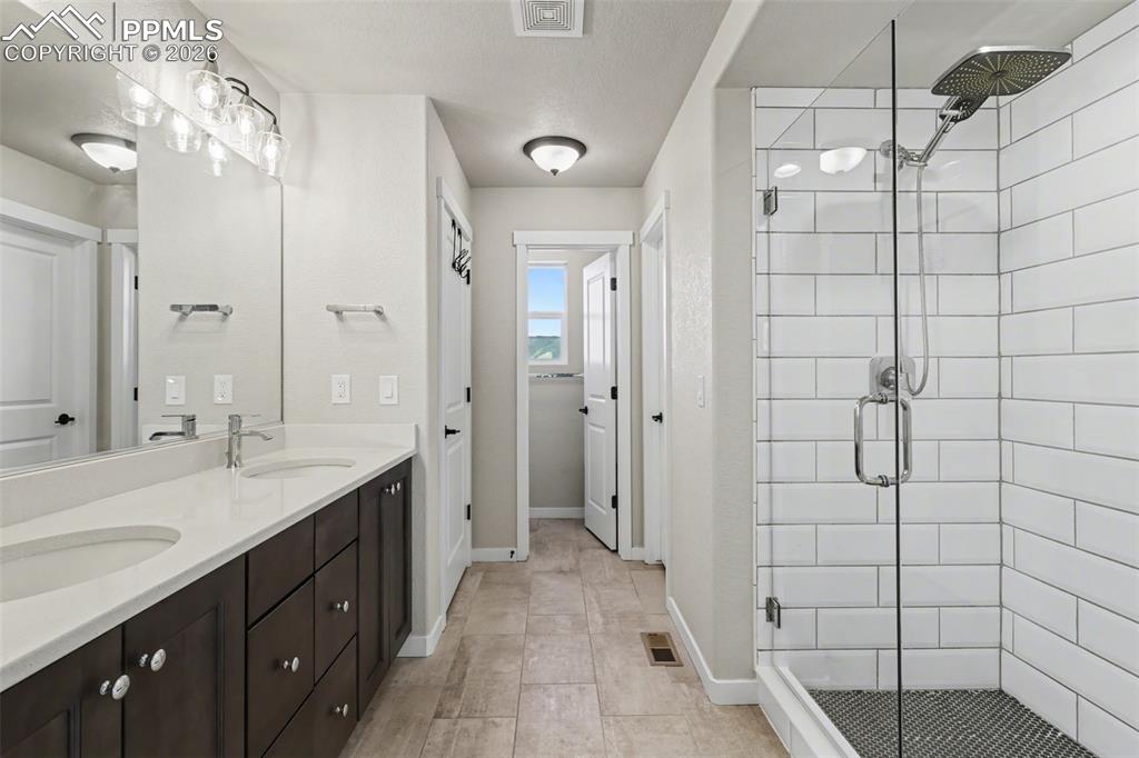 Image 24 of 45: primary bathroom with two sinks