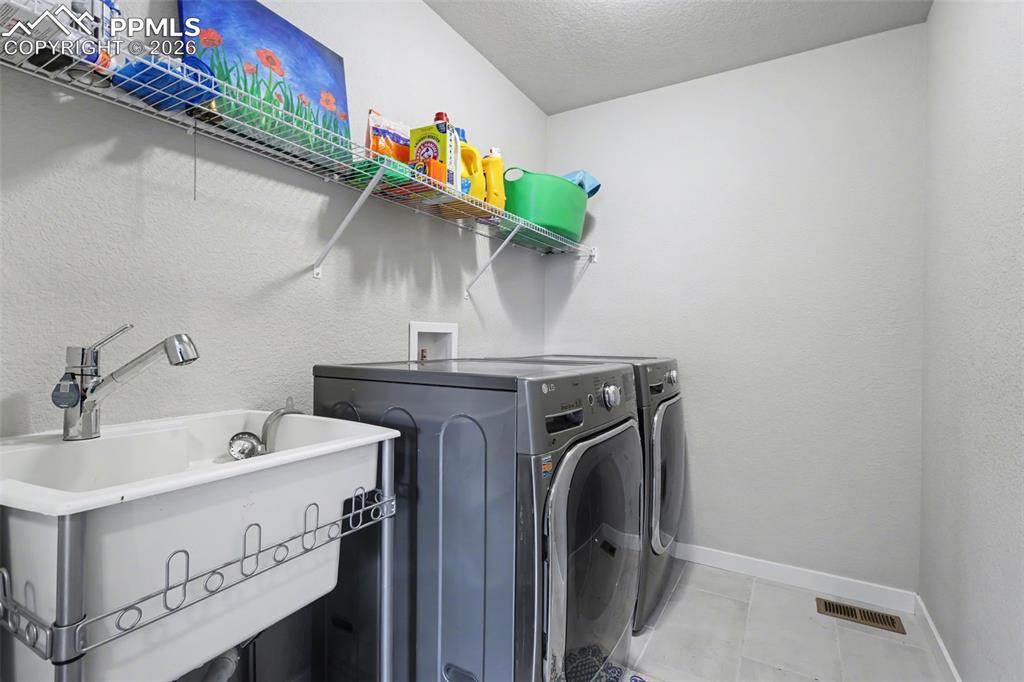 Image 37 of 45: Upstairs Laundry with sink
