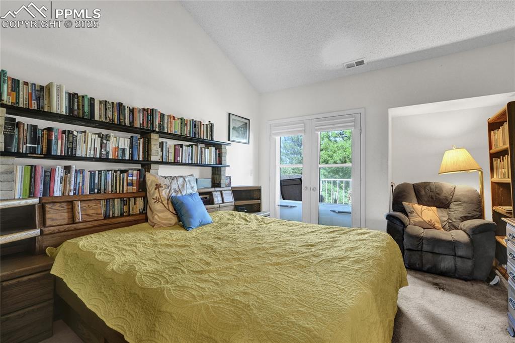 Image 11 of 22: Carpeted bedroom featuring access to exterior  balcony.