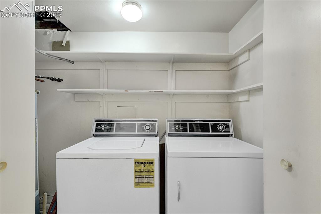 Image 15 of 22: Washroom with washing machine and clothes dryer