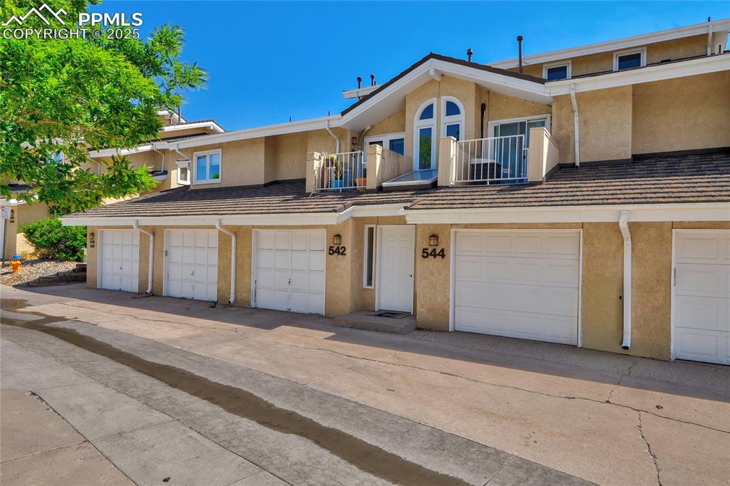 Image 2 of 22: Multi unit property featuring stucco siding and a balcony