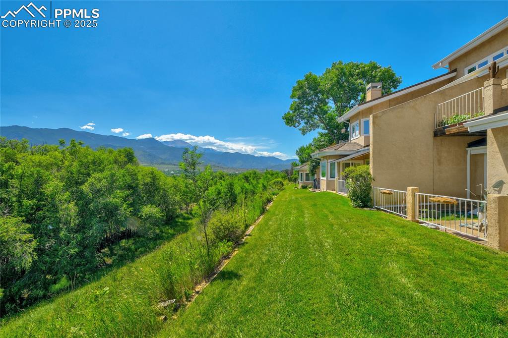 Image 22 of 22: View of green lawn with a mountain view