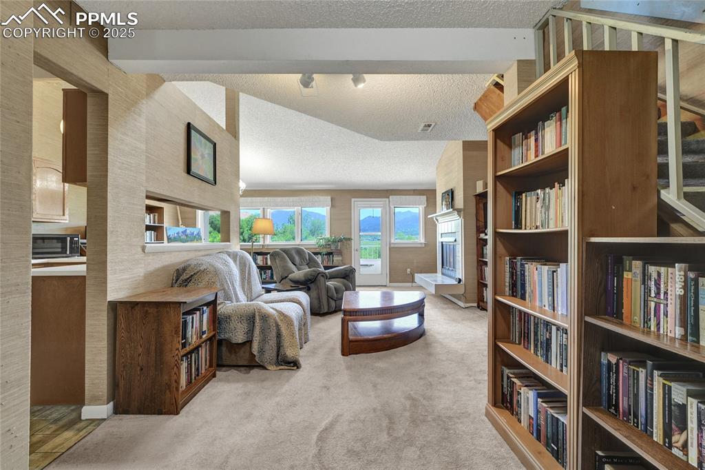 Image 5 of 22: Living area from front door with picturesque windows