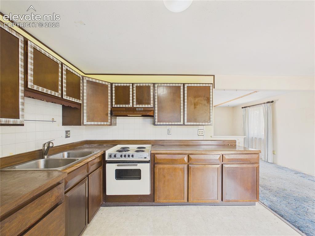 Image 14 of 50: Another view highlights the efficient layout, plentiful cabinetry, and natu