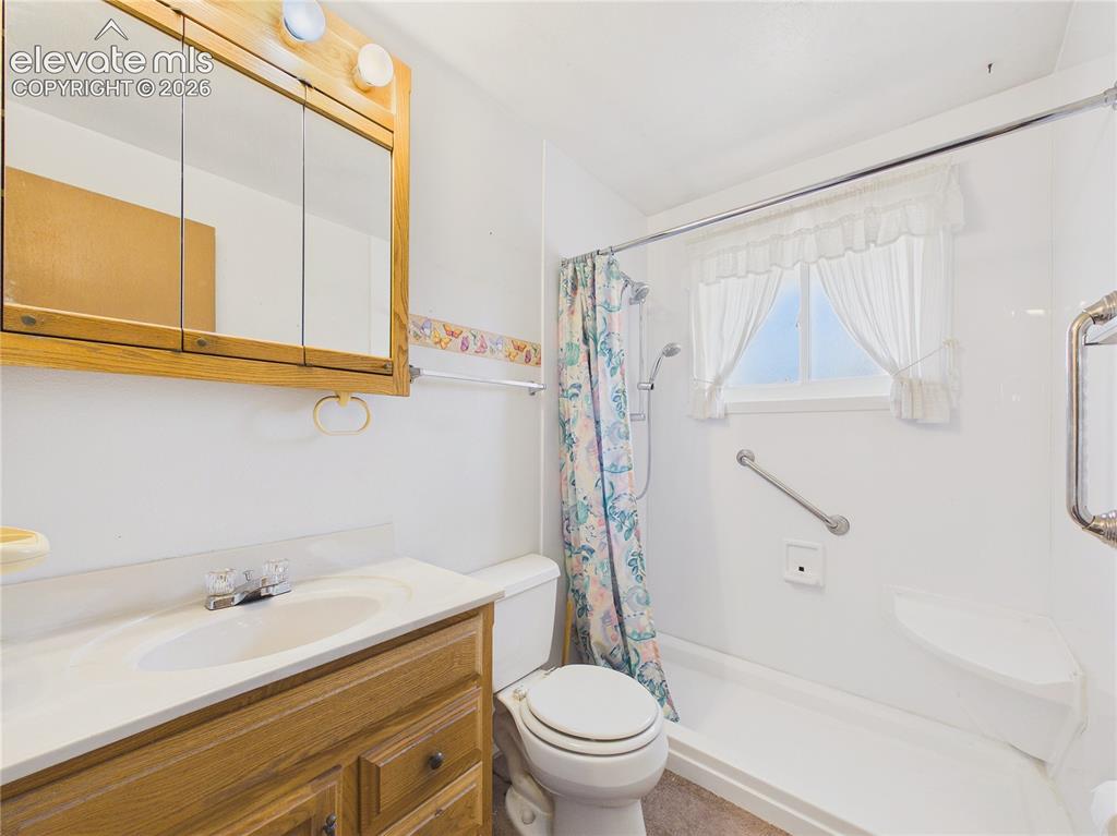 Image 20 of 50: Full bathroom features a single-sink vanity, mirrored medicine cabinet, and