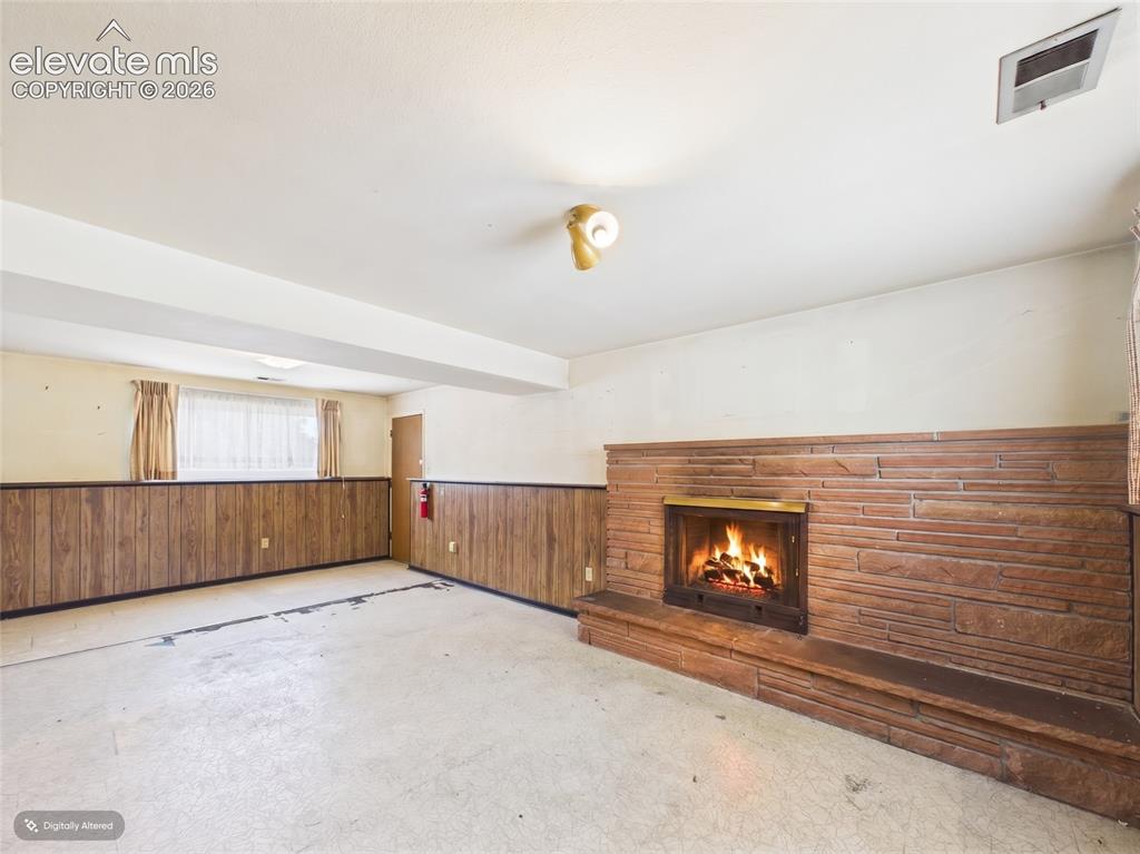 Image 22 of 50: Another view highlights the expansive layout, wood-accent wall detailing, a
