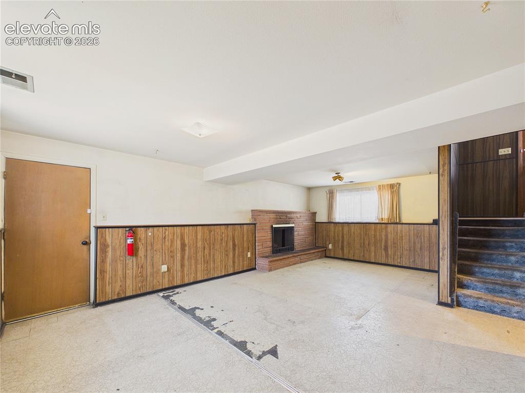 Image 23 of 50: Open lower-level family room provides easy access to the staircase, adjacen