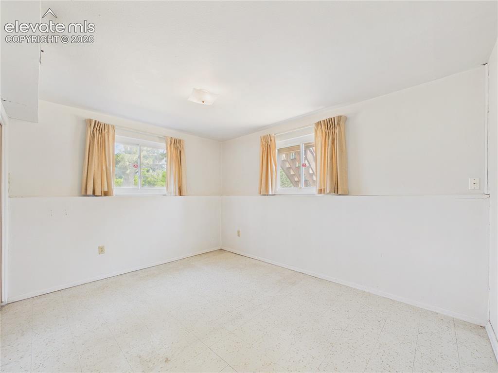Image 27 of 50: Spacious bedroom offers a neutral backdrop ready for your personal style an