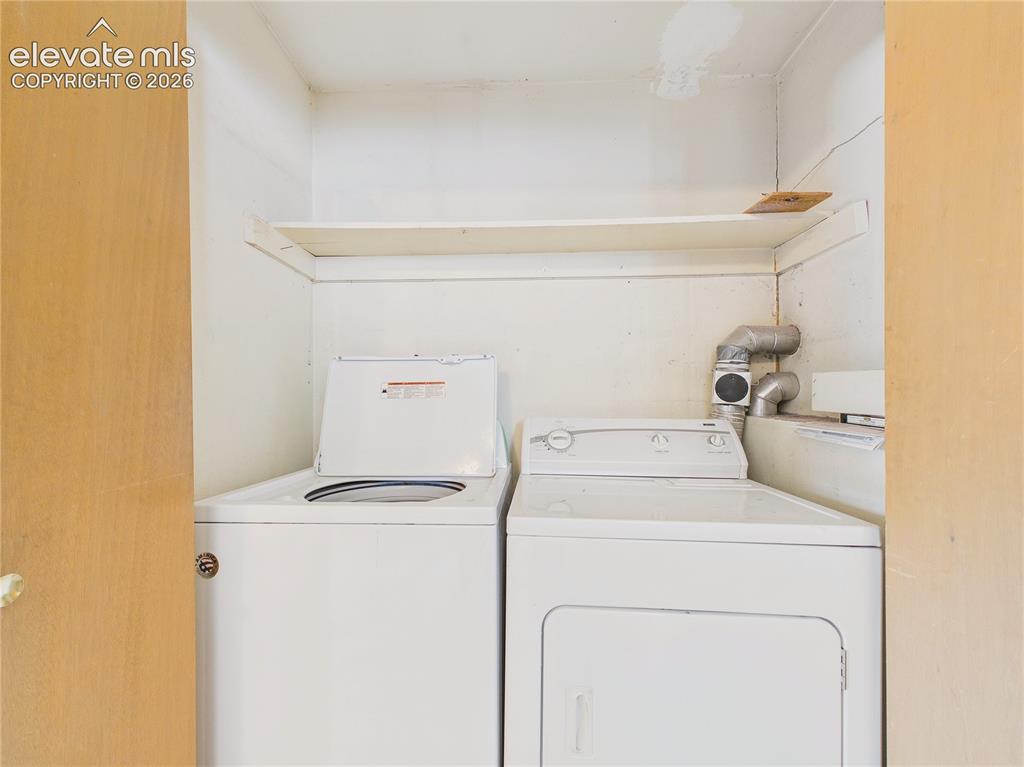 Image 30 of 50: Convenient laundry area includes washer and dryer hookups with built-in she