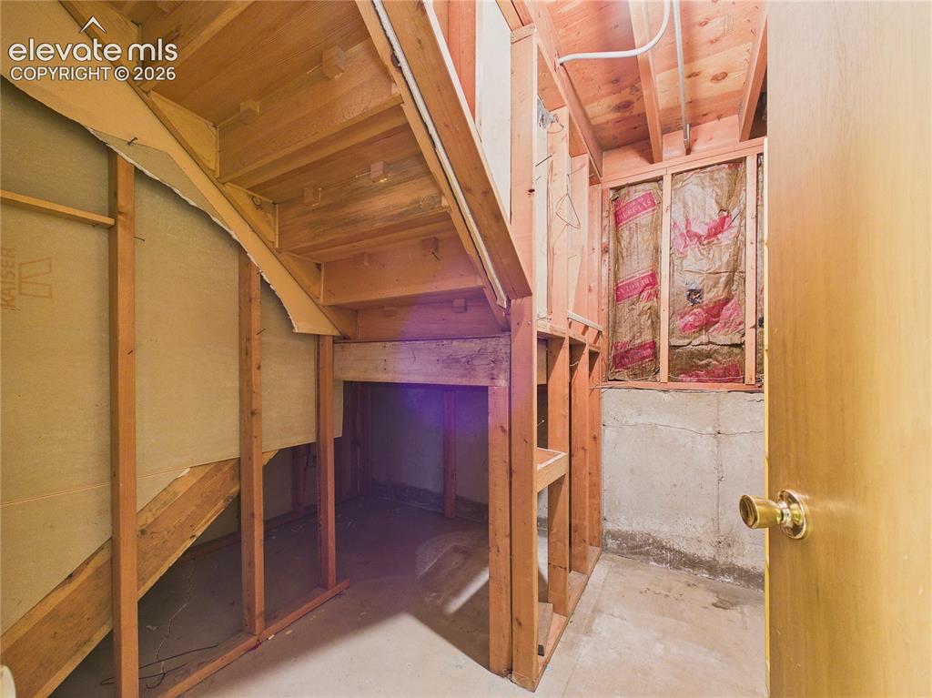 Image 31 of 50: Under-stair storage area offers convenient space for seasonal items, tools,