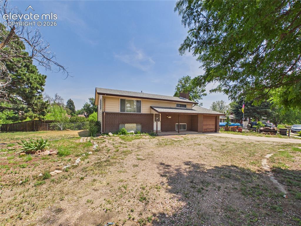 Image 35 of 50: Street-side view highlights the expansive corner lot, mature landscaping, a