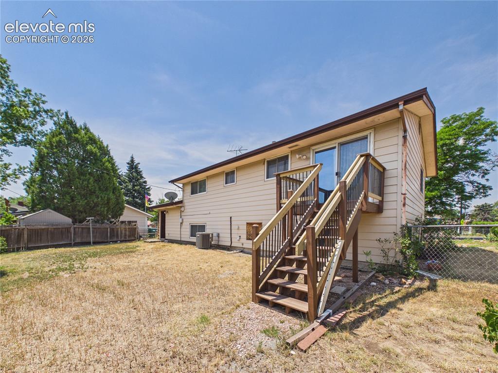 Image 37 of 50: Backyard & Deck – Elevated deck with modern railing offers the perfect spac