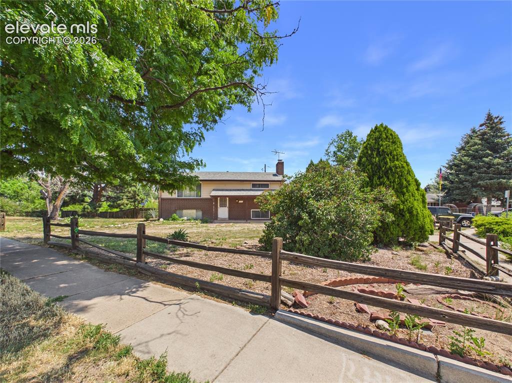 Image 39 of 50: Front Exterior – Street-side view highlights the expansive corner lot, matu