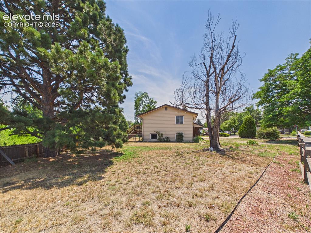 Image 40 of 50: Side Yard – Large side yard with mature trees provides additional outdoor s