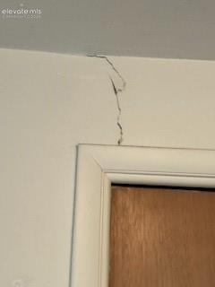 Image 48 of 50: Wall Crack Above Door Interior Wall Detail – Visible crack above the doorwa
