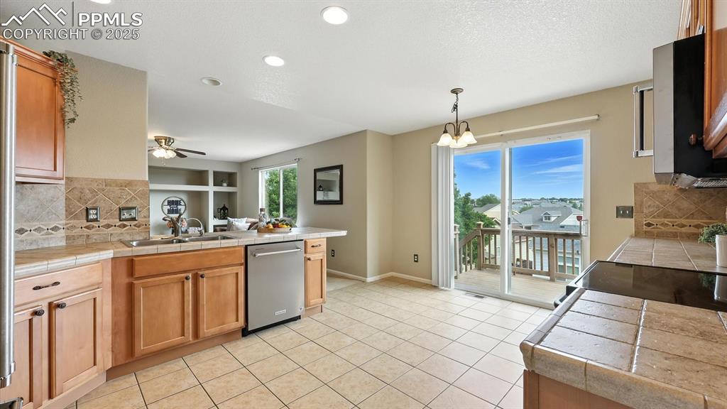 Image 12 of 50: Spacious tiled Kitchen.