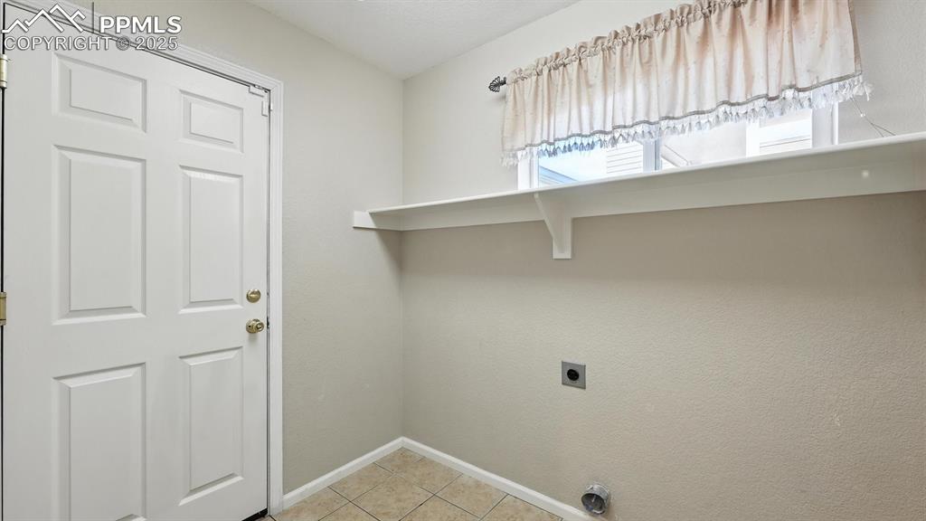Image 18 of 50: The Laundry Room has electrical hook ups, a built-in shelf, and convenient 