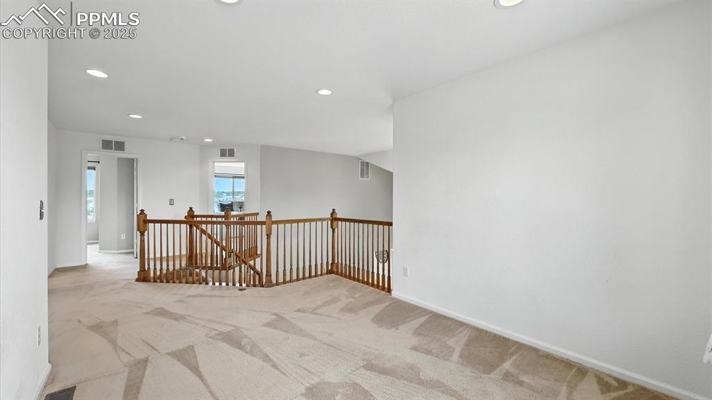 Image 28 of 50: Large, versatile upper level Loft with neutral carpet.