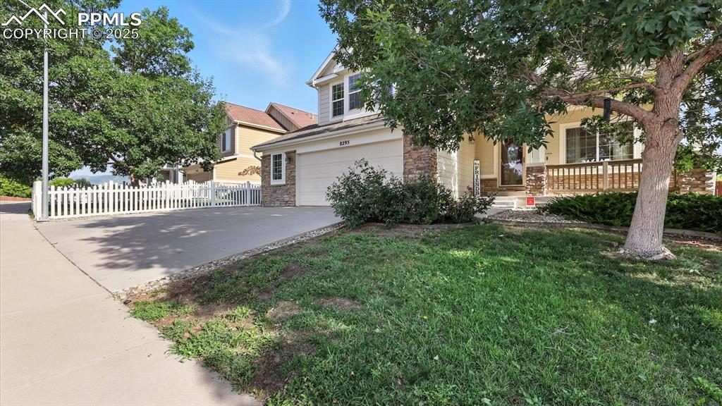 Image 3 of 50:  Situated on a nicely landscaped lot with auto sprinklers, mature trees, & 