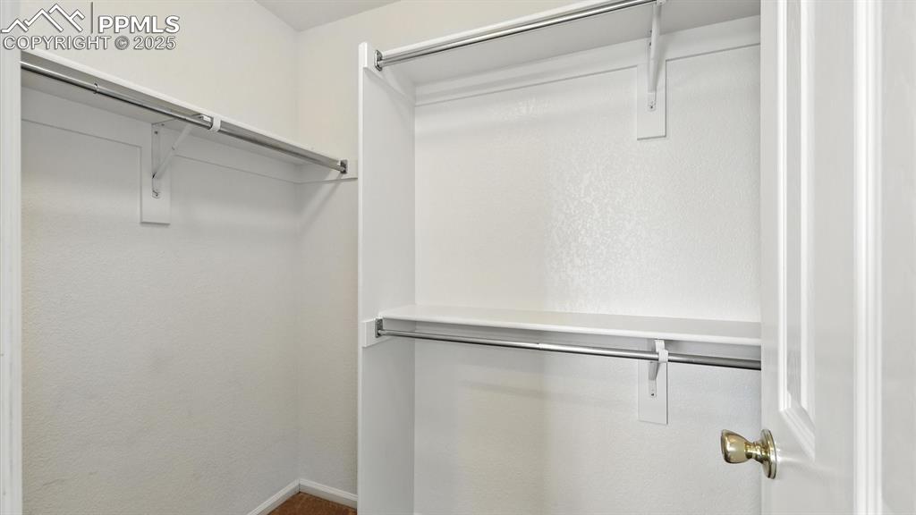 Image 34 of 50: Walk in closet in the Primary Suite.