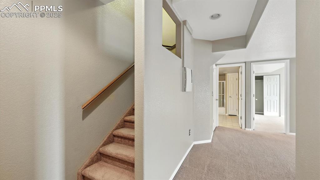 Image 36 of 50: Stairs to the finished walk-out Basement.