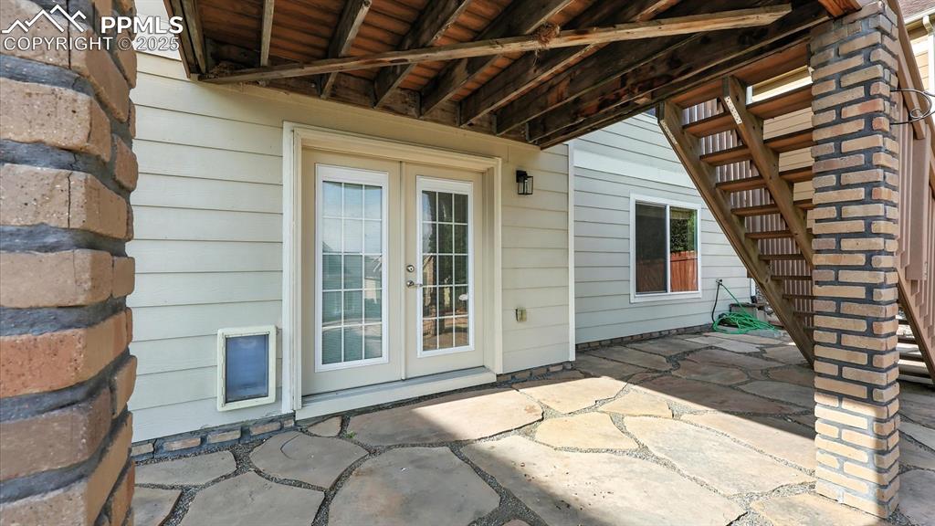 Image 39 of 50: Backyard covered flagstone patio off the basement Rec Room for outdoor ente
