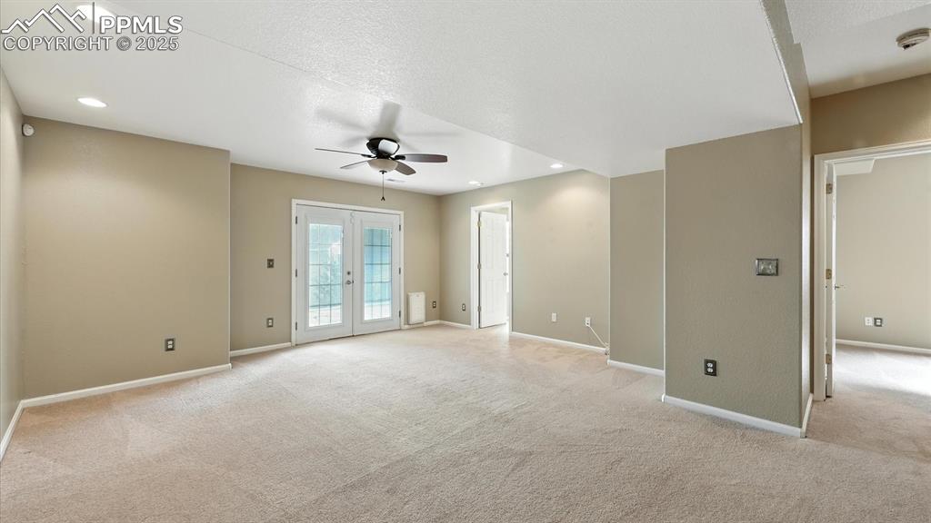 Image 40 of 50: Basement Family/Rec Room with neutral carpet, a lighted ceiling fan, and Fr