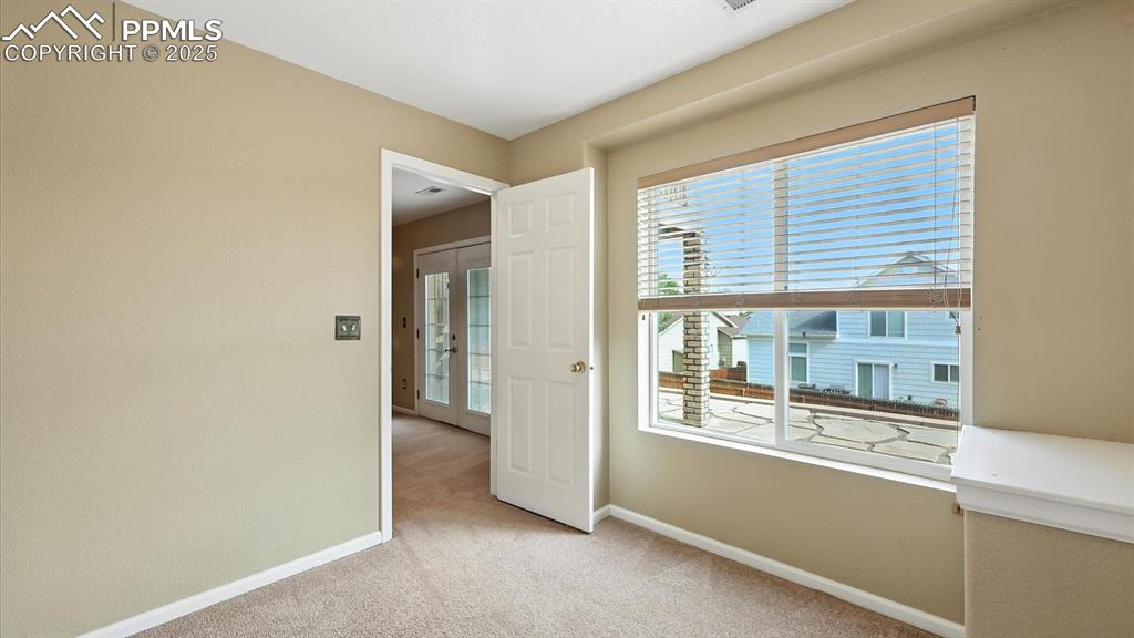 Image 43 of 50: Basement Home Office with backyard views.