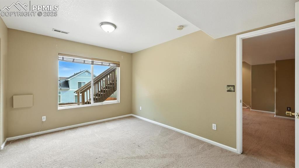 Image 45 of 50: Basement Bedroom #4 with backyard views.