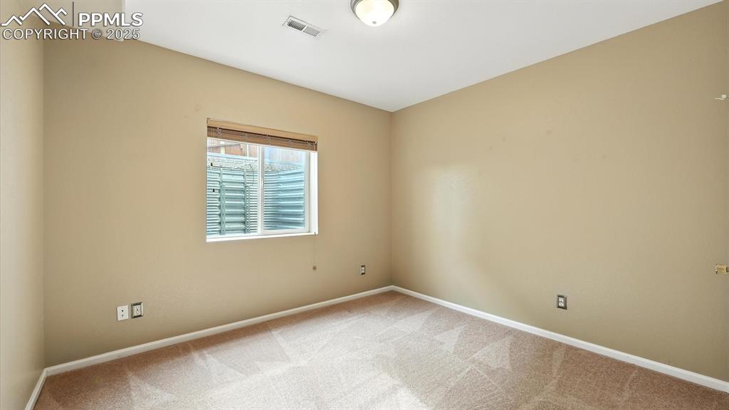 Image 46 of 50: Basement Bedroom #5 with neutral carpet.