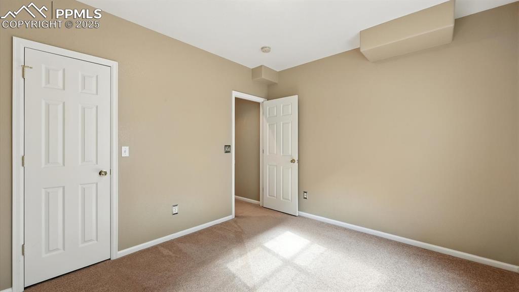 Image 47 of 50: Basement Bedroom #5 with a walk in closet.