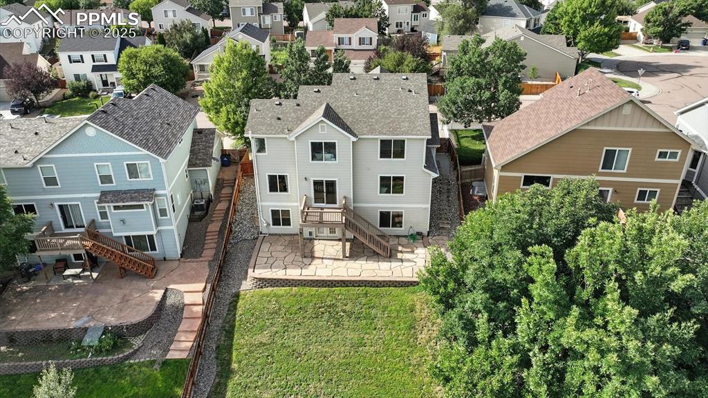 Image 50 of 50: Aerial rear view of home and fenced backyard.
