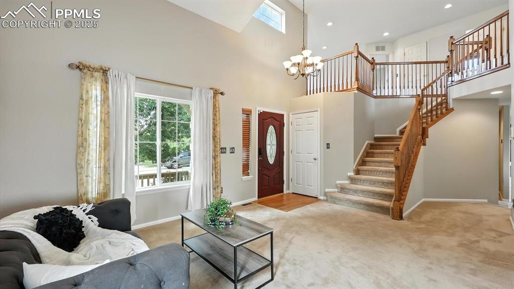 Image 6 of 50: Wood floor foyer featuring a stunning stained-glass front door, modern ligh