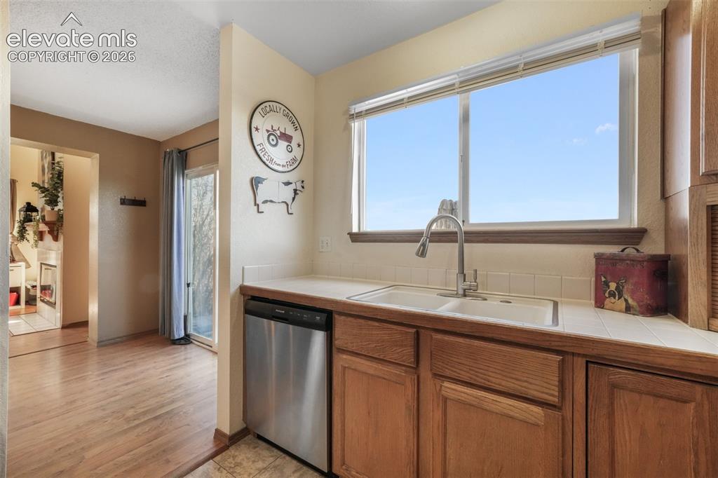 Image 15 of 50: Kitchen area featuring wood-finish flooring, a double-basin sink with a goo