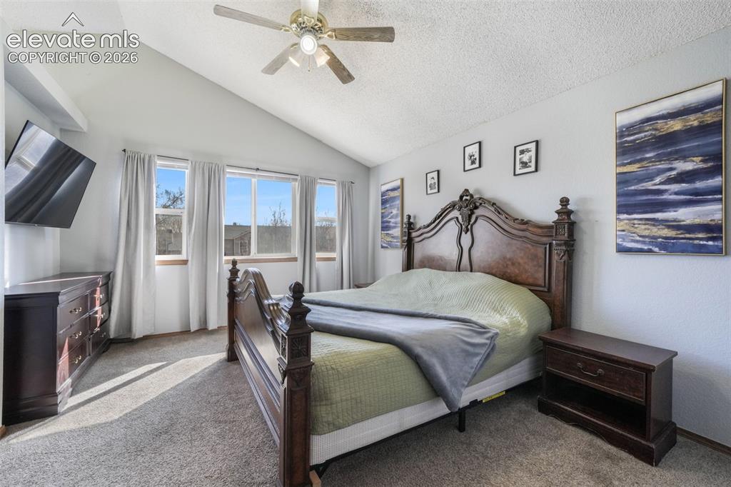 Image 29 of 50: Vaulted ceiling featuring a ceiling fan with integrated lighting