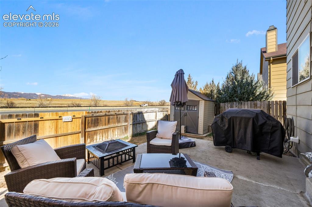Image 41 of 50: Outdoor patio featuring a concrete surface, privacy fencing, and a built-in