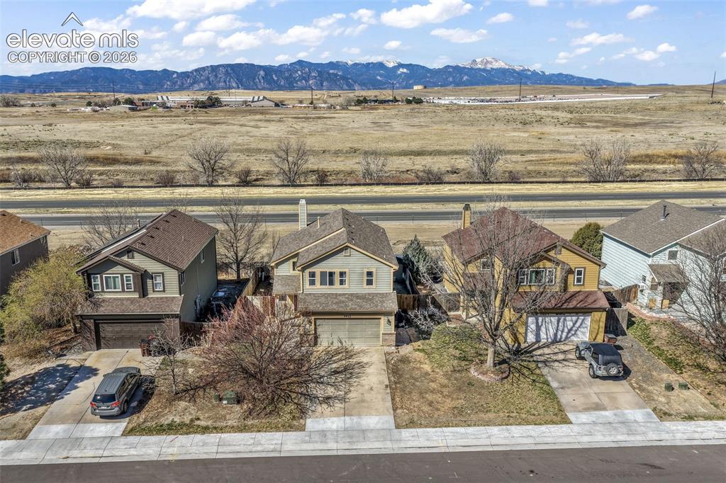 Image 49 of 50: Two-story residence featuring a two-car garage and a paved driveway