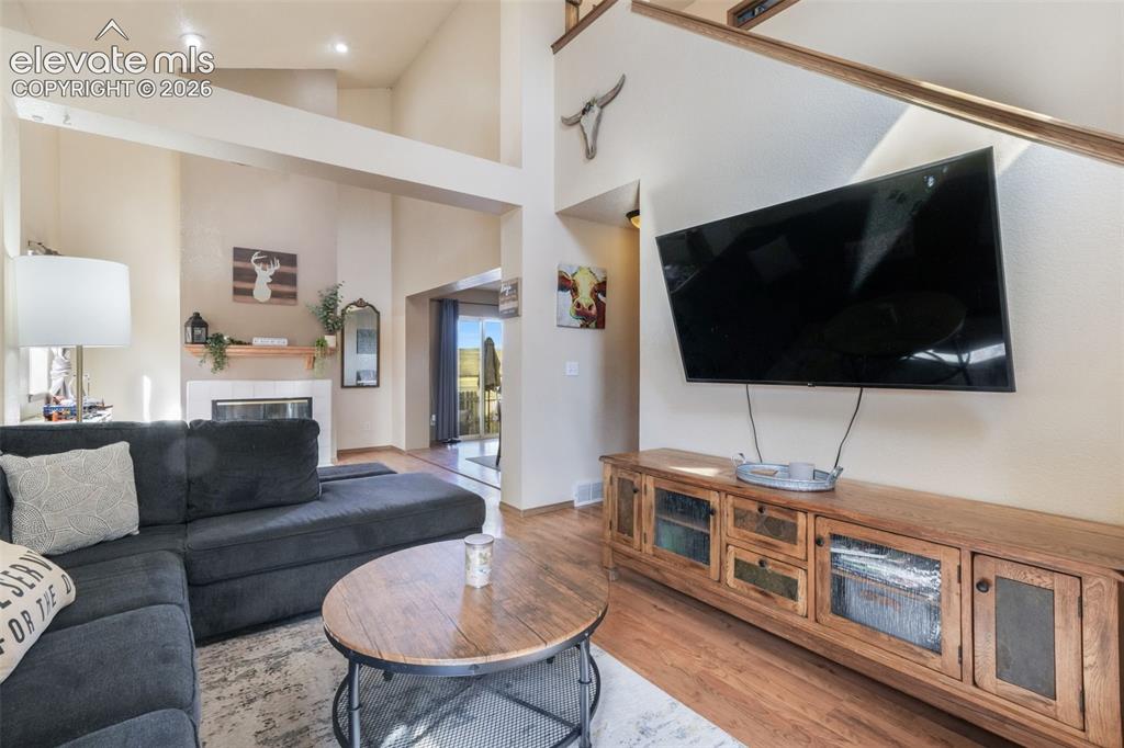 Image 5 of 50: Living area featuring high ceilings with recessed lighting, an integrated f