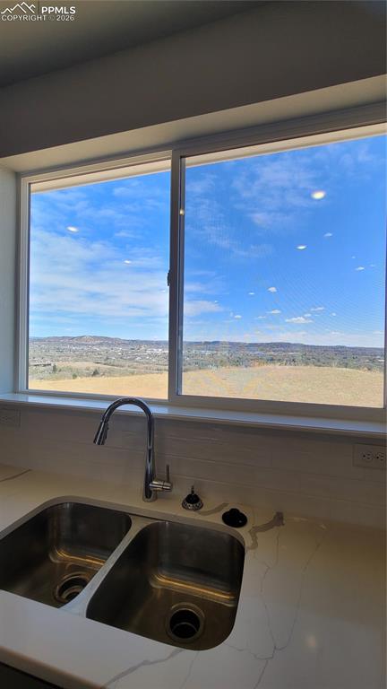 Image 14 of 39: Kitchen with quartz countertop, pantry, large island providing additional s